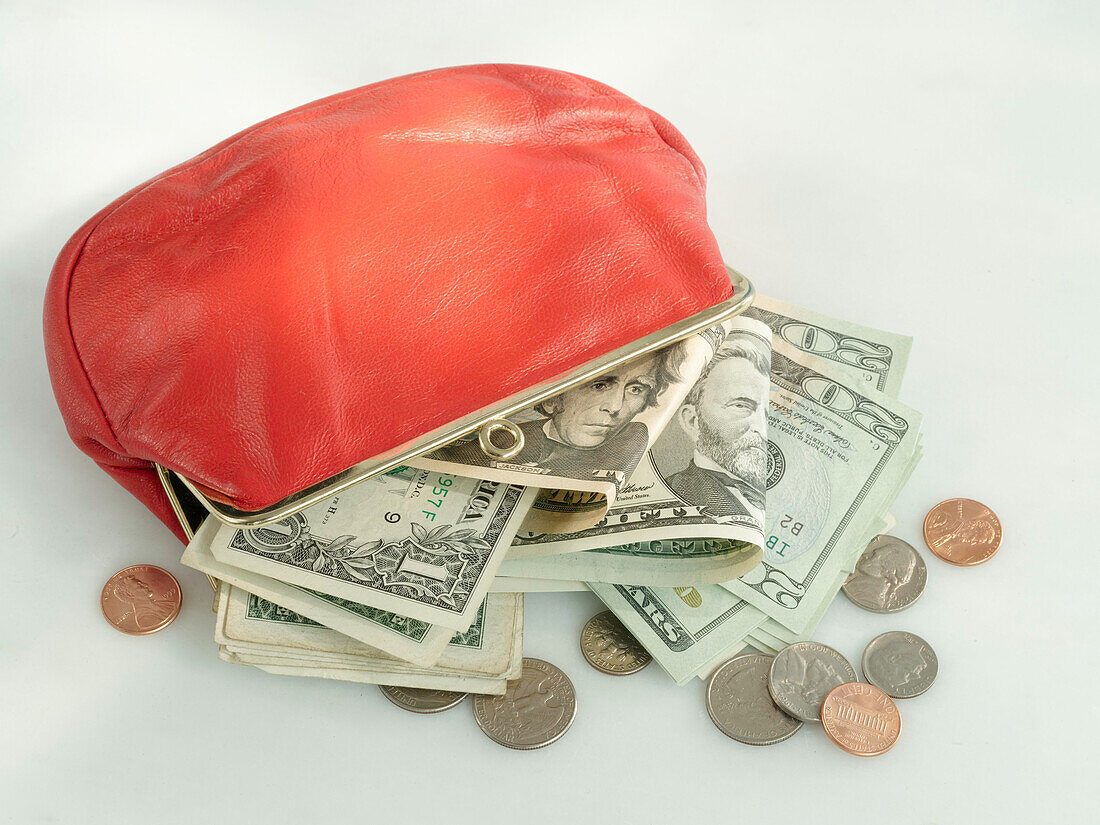 Red purse with dollar notes and coins