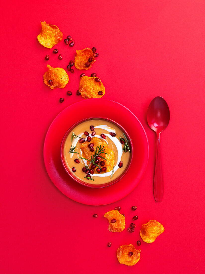 Pumpkin cream soup with pomegranate seeds