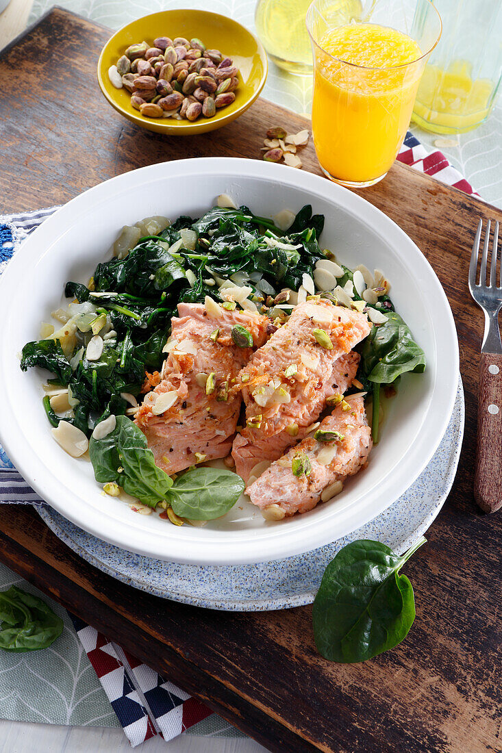 Roasted salmon with spinach, almonds and pistachios