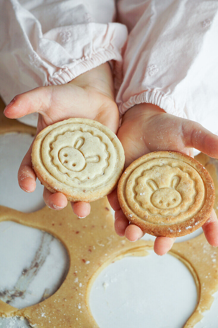 Girl's hands holding Easter cookies