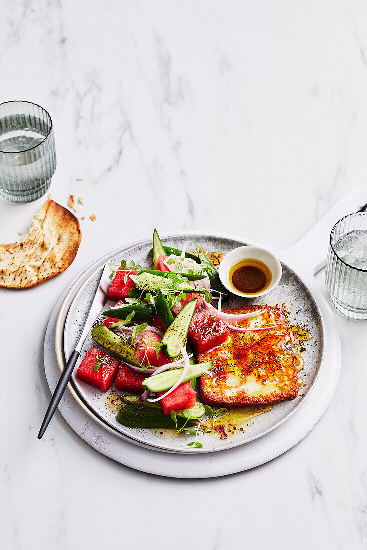 Saganaki with watermelon and cucumber salad