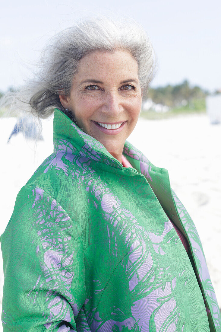 Gray-haired woman in a green coat