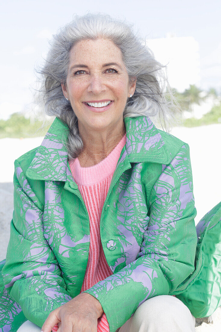 Gray-haired woman in a green coat