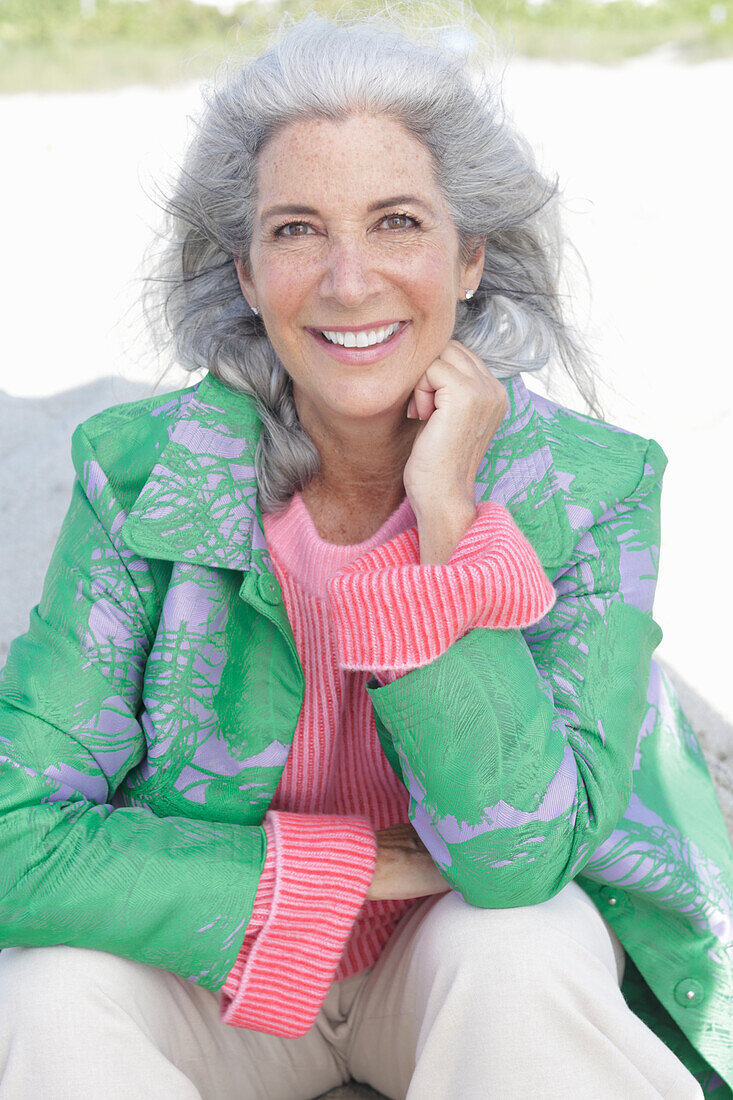 Gray-haired woman in a green coat