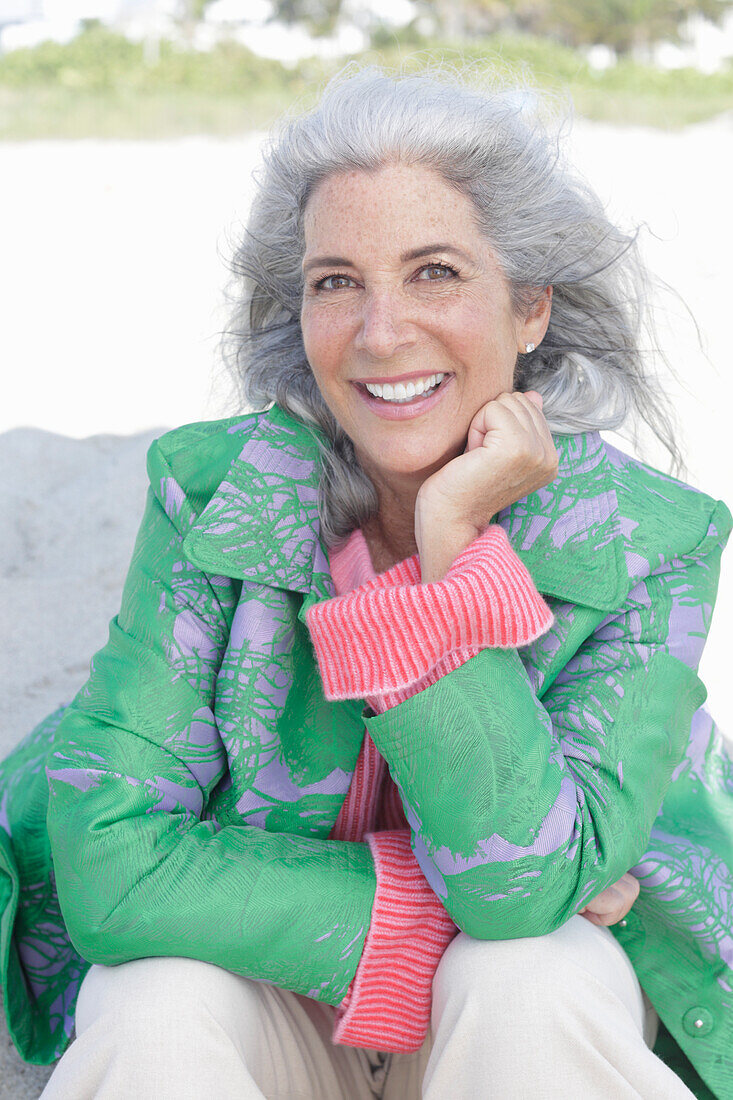 Gray-haired woman in a green coat