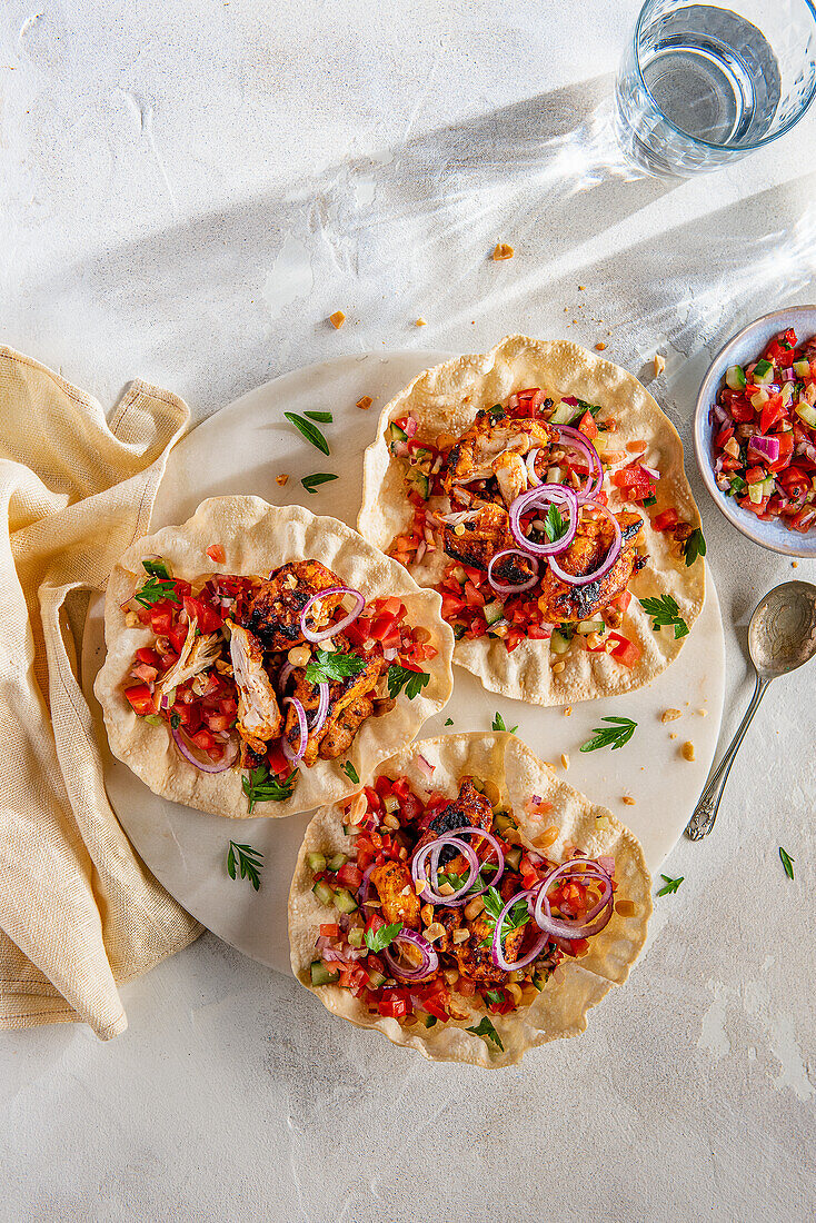 Poppadoms with Kachumber salad and chicken marinated in yoghurt and curry spices