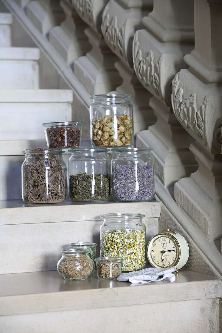 Various tea herbs in jars on stairs