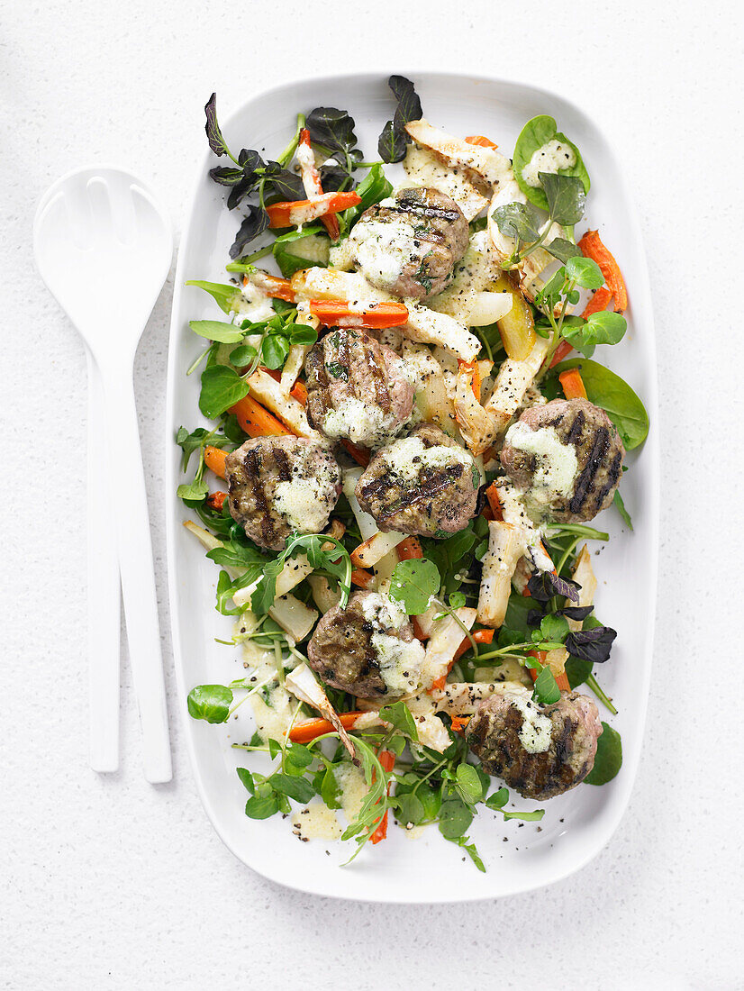 Roasted root vegetable salad with turkey patties and parmesan dressing