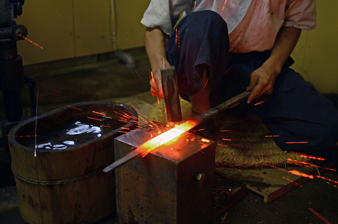 Japanese swordsmith working at his studio