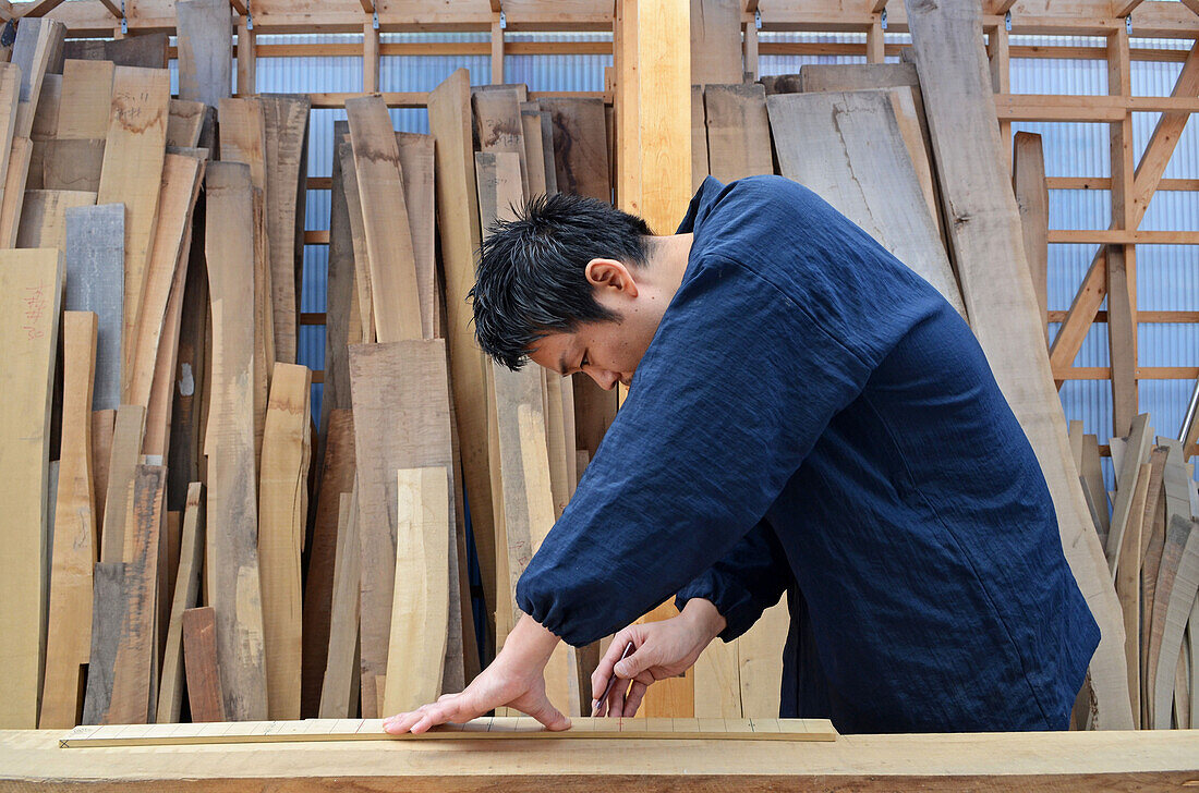 Japanese sword scabbard maker working at his workship