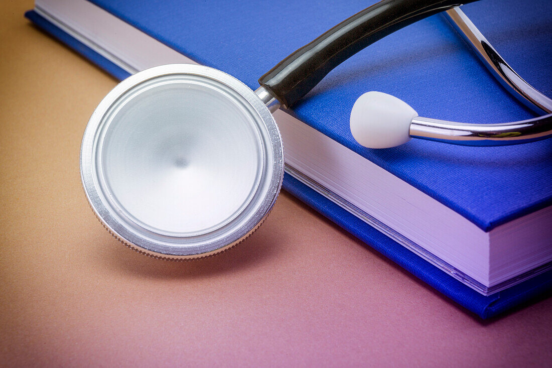 Stethoscope next to a book
