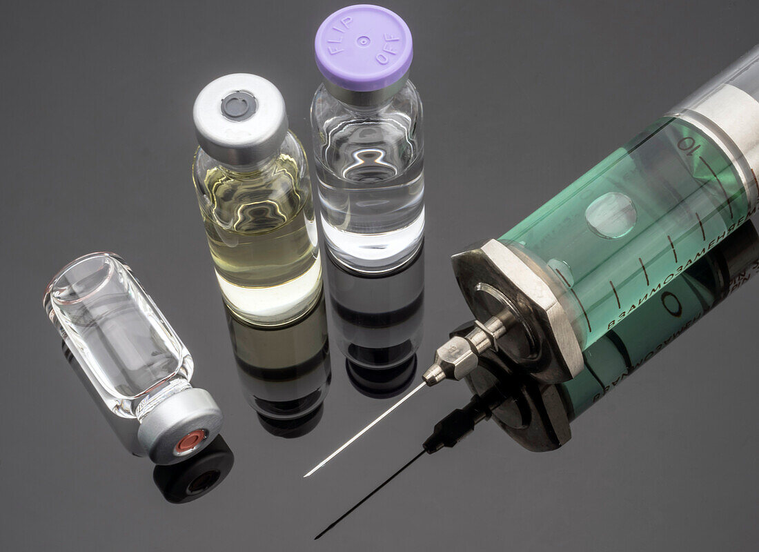 Syringe next to vials