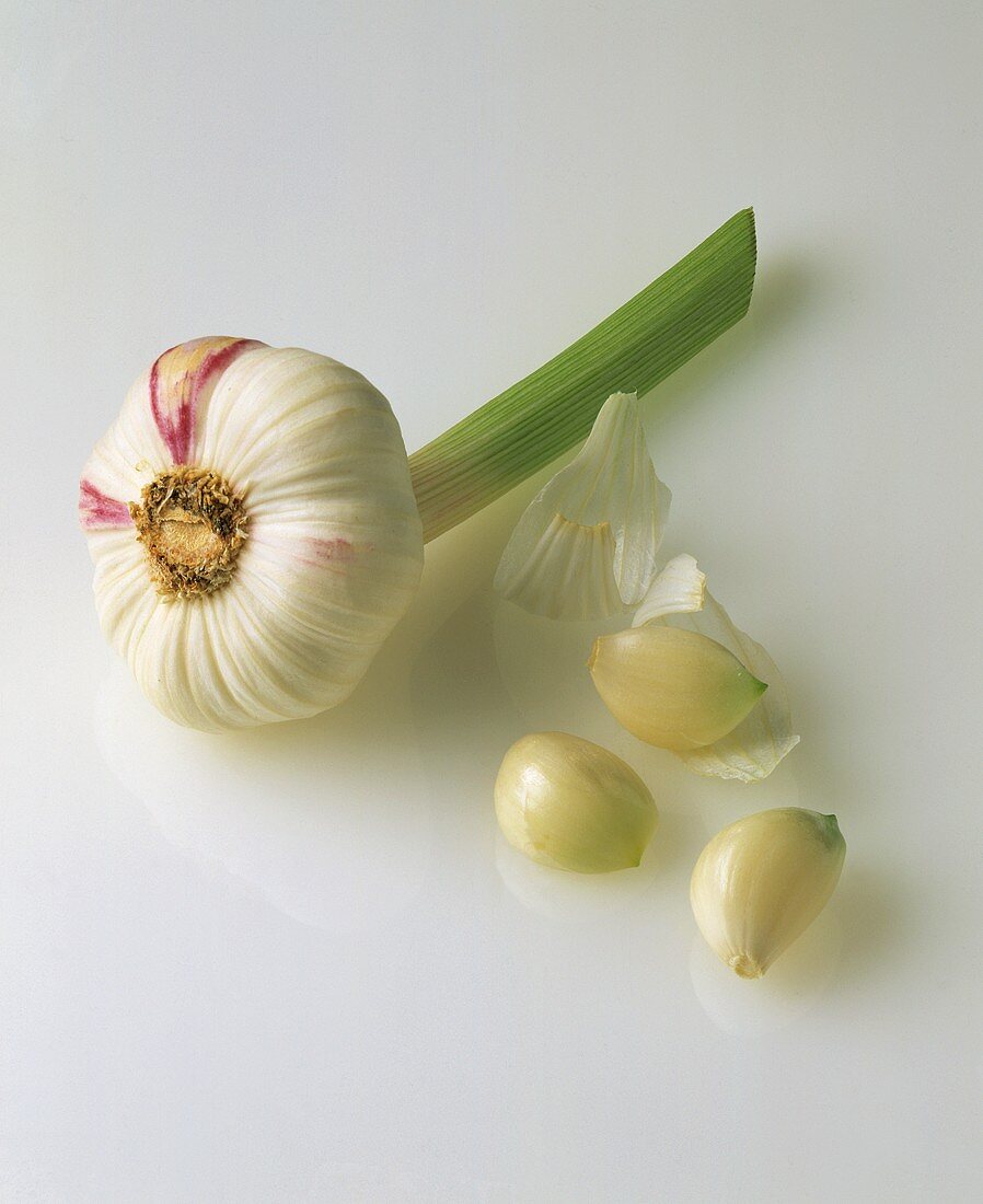 A garlic bulb and three cloves of garlic