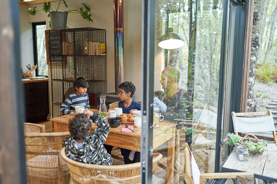 Family eating at dining table in cabin