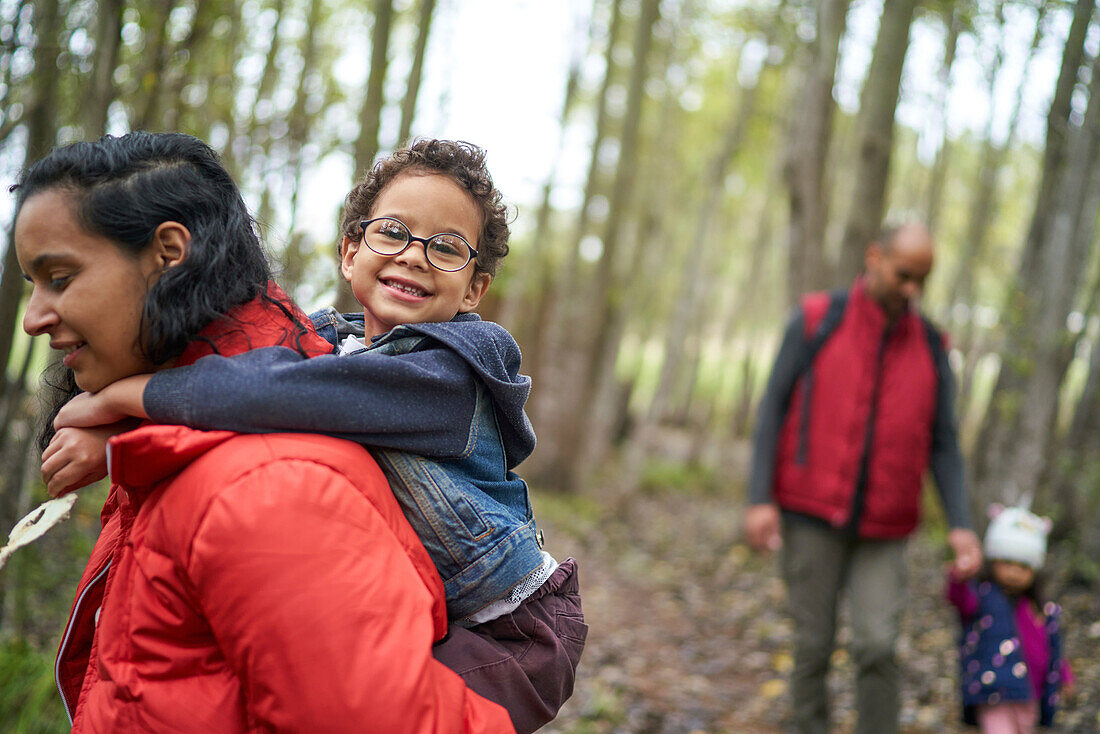 Happy family hiking in woods