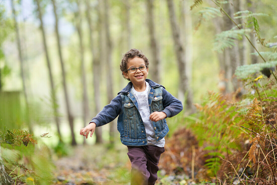 Happy boy running in woods