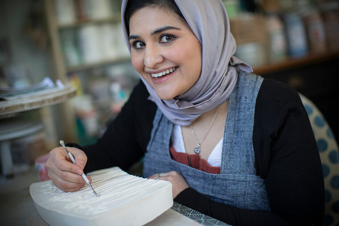 Happy woman in hijab in art studio