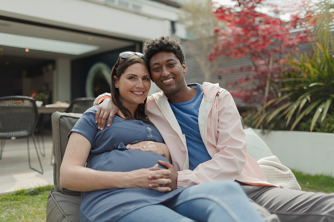 Happy pregnant couple on patio