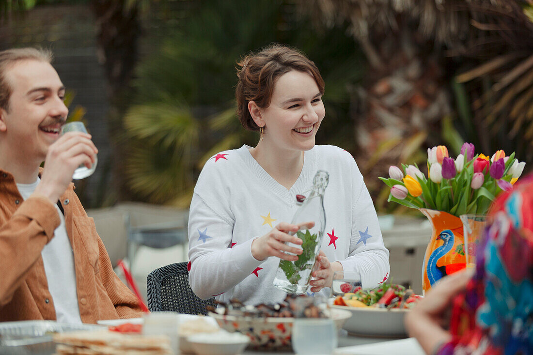 Happy couple enjoying lunch at patio table