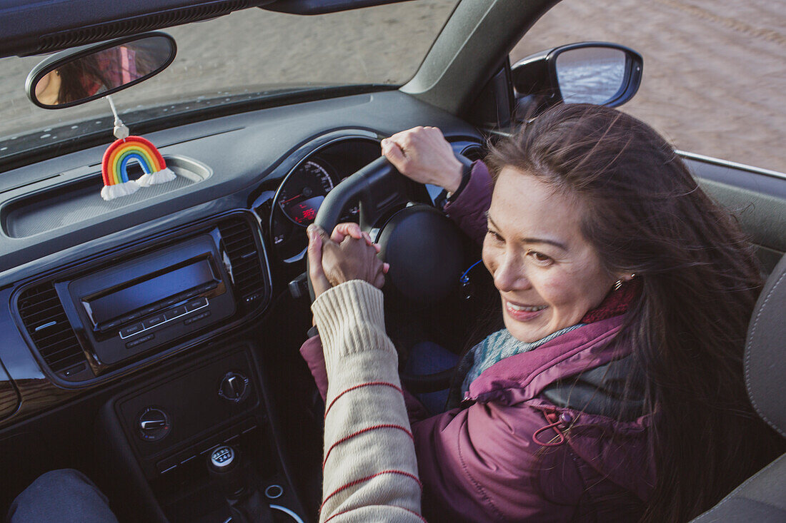 Happy woman driving convertible