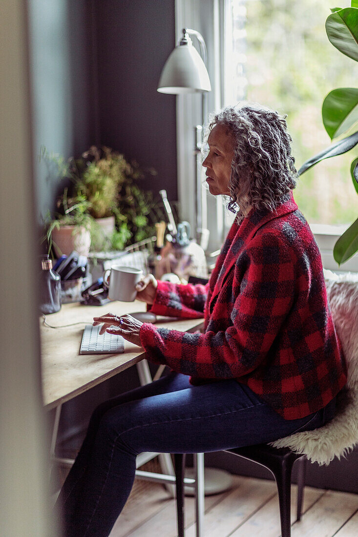Woman working at desk in home office