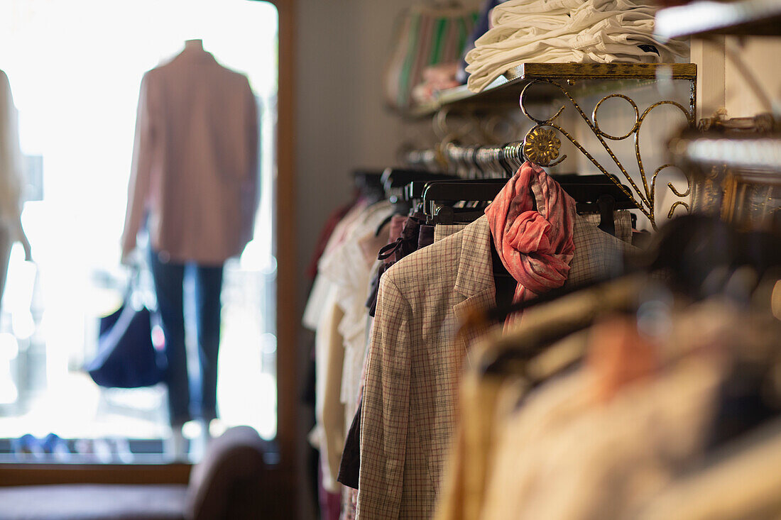 Clothes hanging on racks in boutique