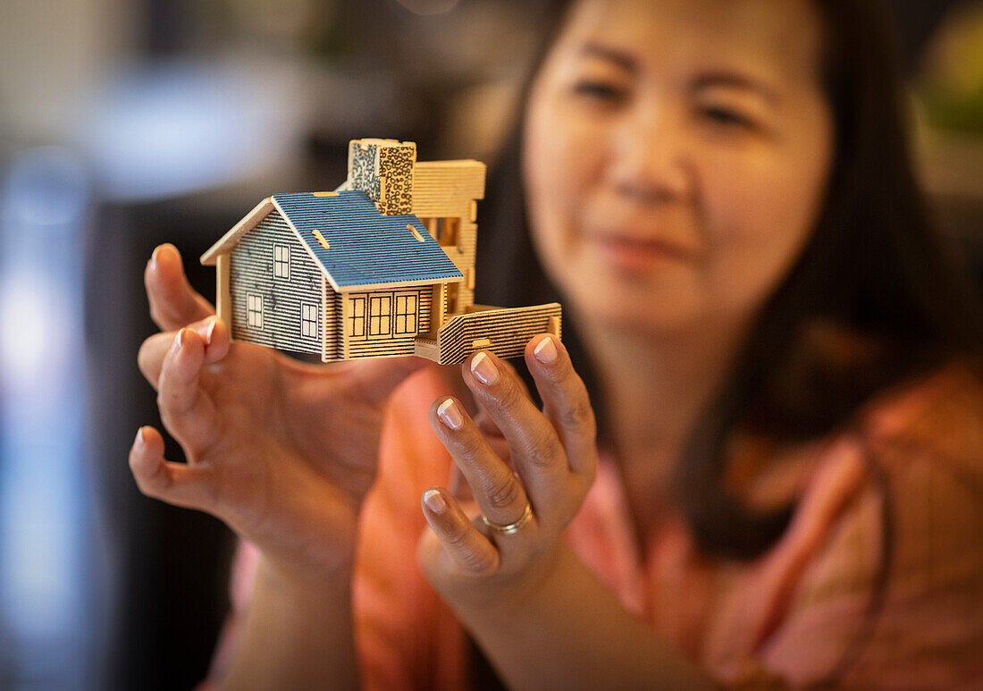 Female architect holding house model