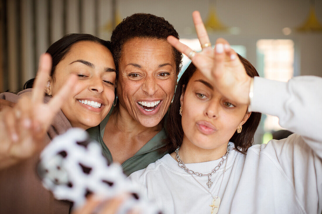 Happy mother and daughters taking selfie