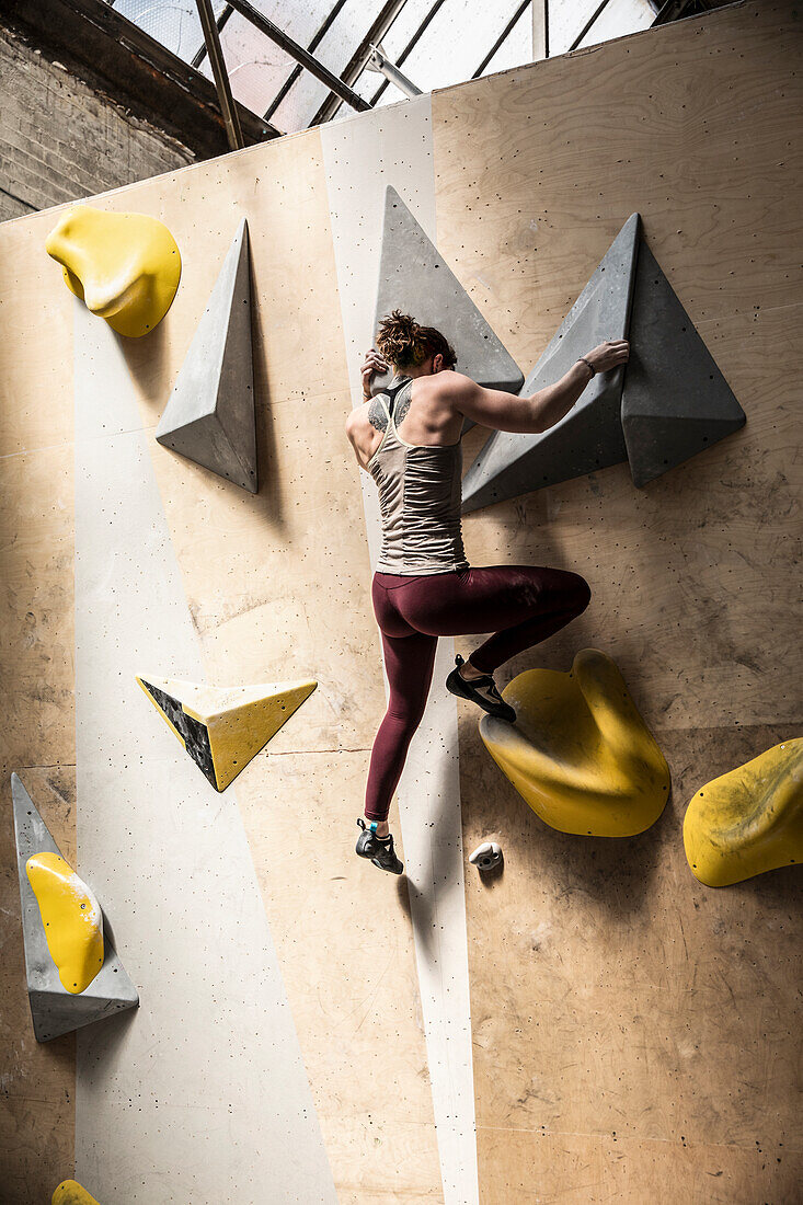 Young woman on climbing wall