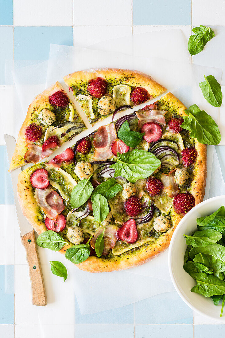 Strawberry pizza with pesto, brie cheese, red onion, bacon and chicken and dill meatballs