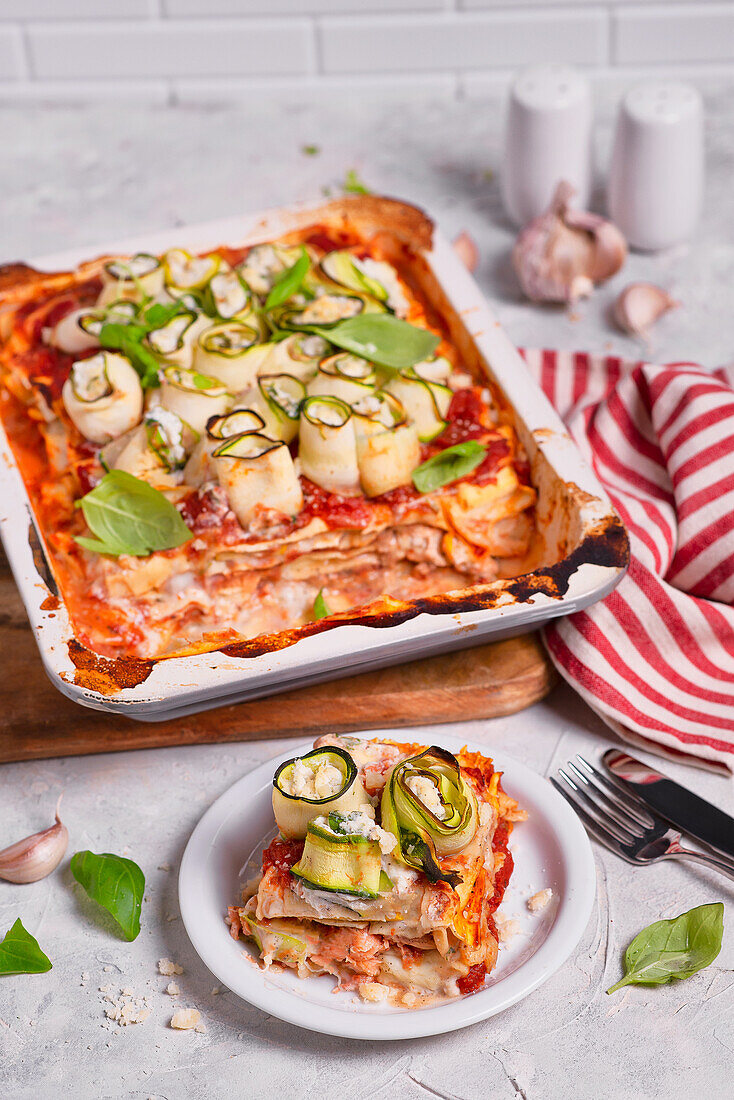 Lasagne with salmon zucchini and zucchini rolls stuffed with herb creamy cheese