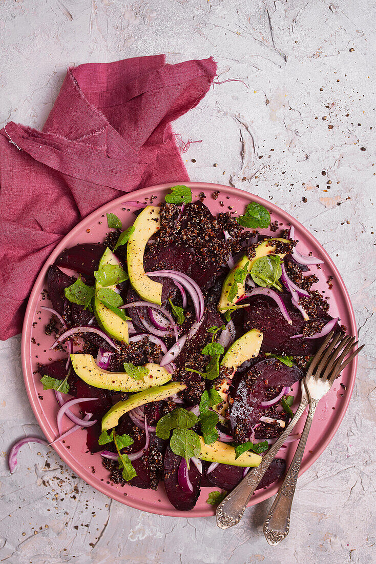 Red quinoa salad with beets, red onion, avocado, and mint