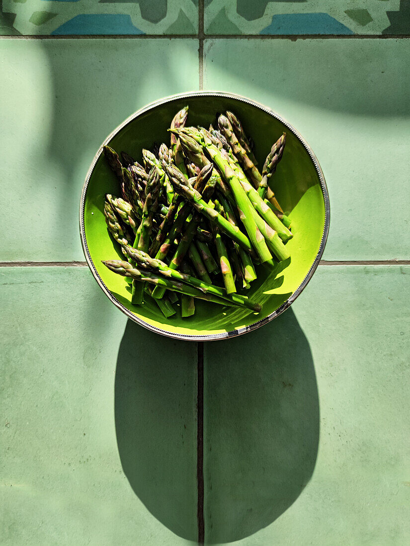 Fresh green asparagus in a bowl