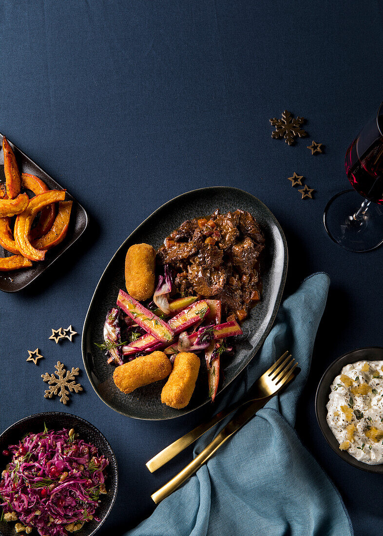 Venison goulash with colourful carrots, radicchio and croquettes for Christmas