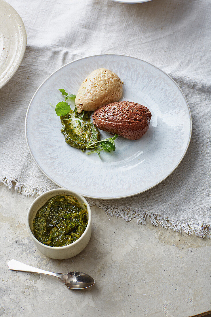 Duet of white and dark mousse with sweet herb pesto