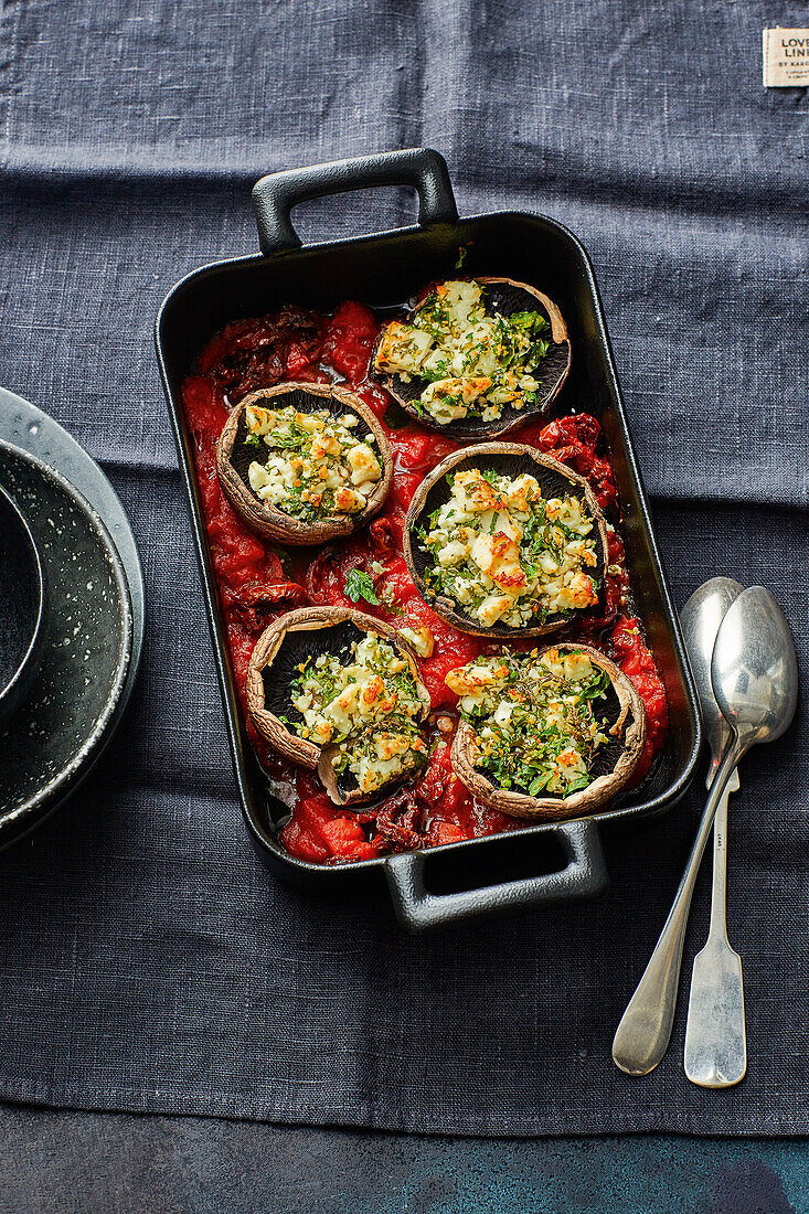 Stuffed mushrooms with herbed feta cheese in tomato sauce