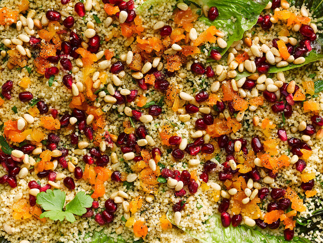 Couscous salad with pomegranate, dried apricots, and pine nuts (picture-filling)