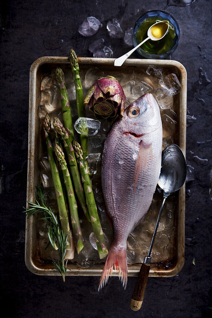 Pink sea bream with artichokes and green asparagus