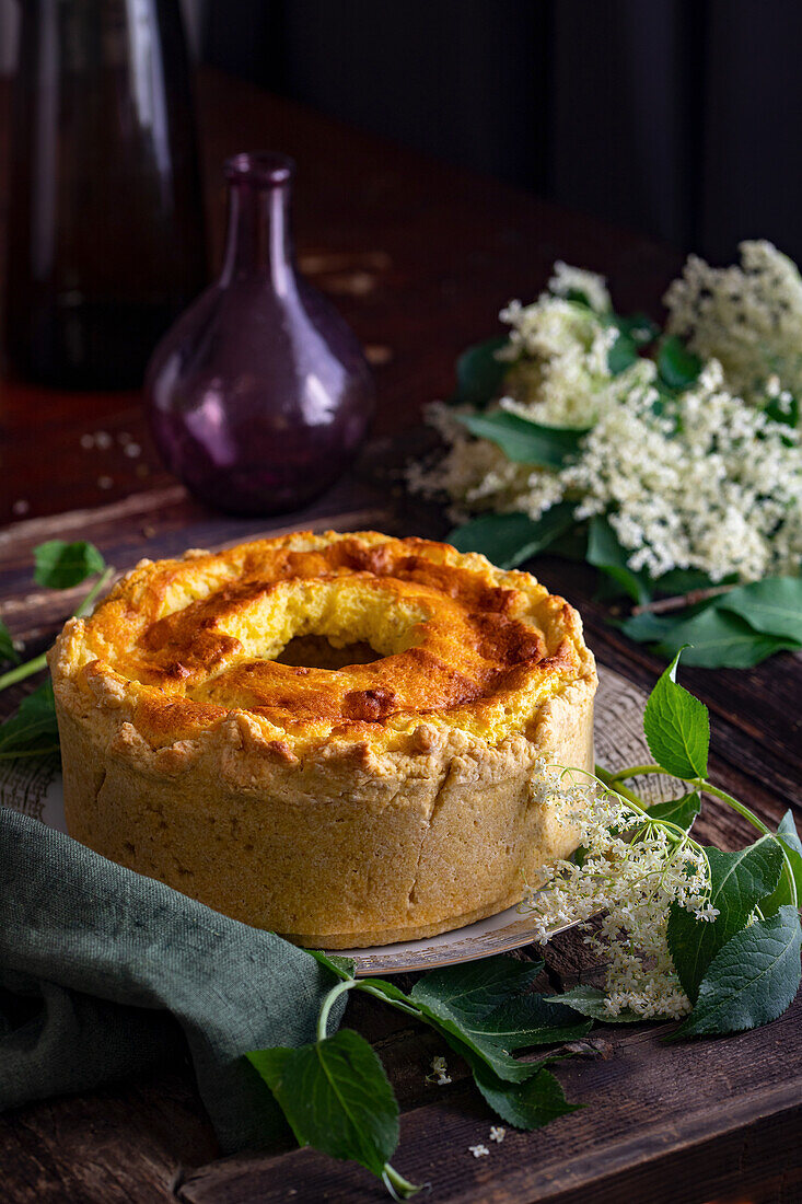 Ricotta cake, surrounded by elderflowers