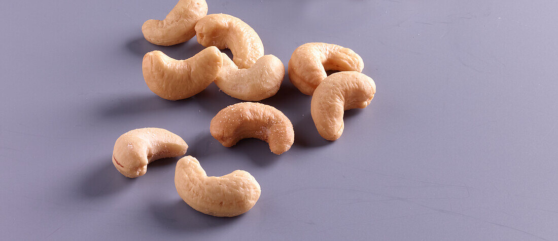 Cashew nuts on a grey background