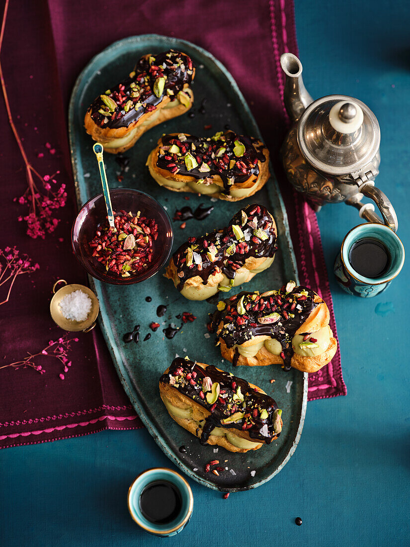 Eclairs with pistachio cream and chocolate icing
