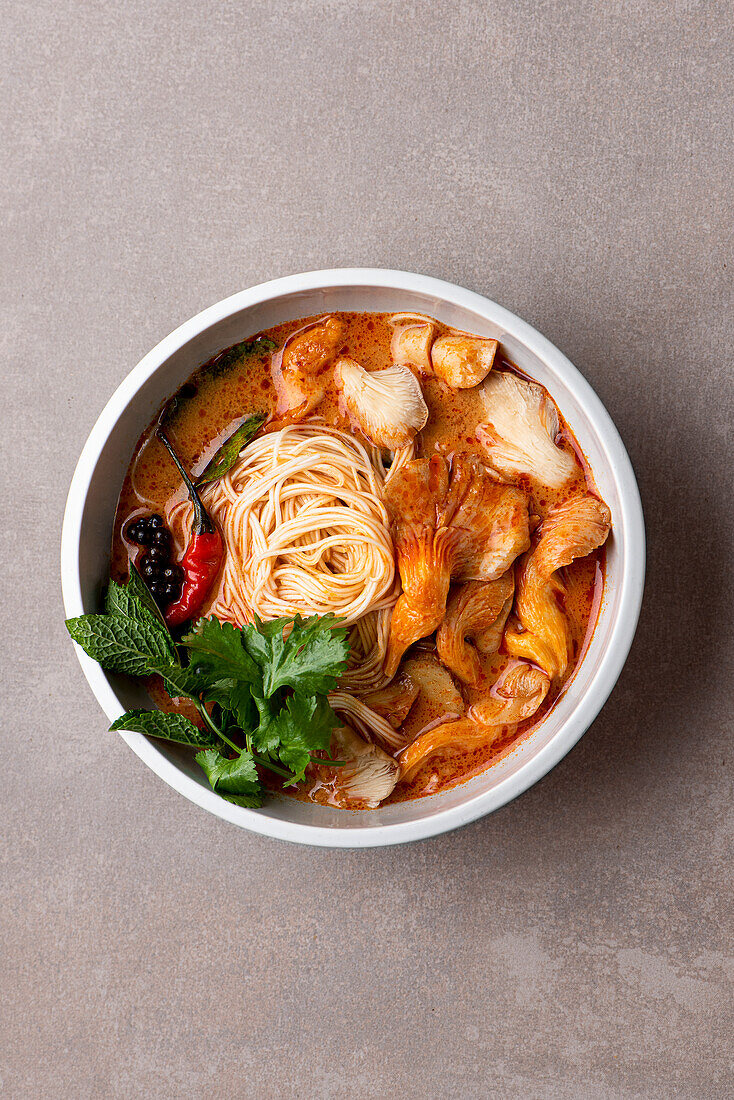 Thai red curry soup with oyster mushroom, chilli, lime leaves, ginger and coriander