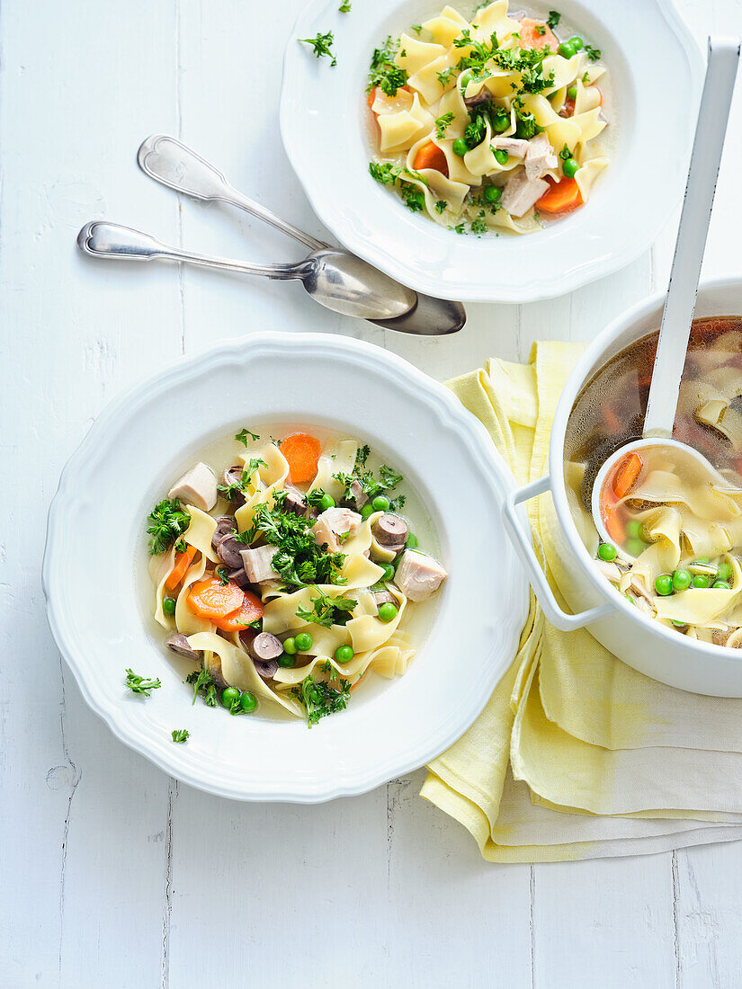 Noodle stew with chicken hearts, peas and carrots