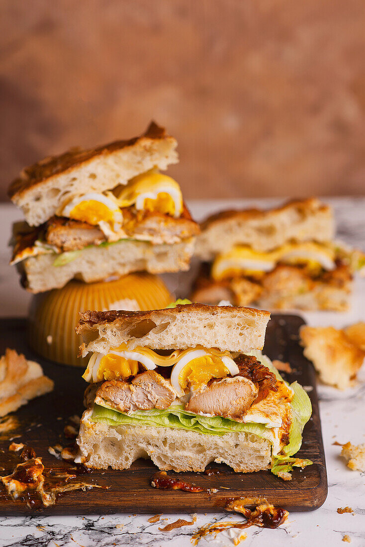 Focaccia sandwiches with iceberg lettuce garlic sauce chicken egg cheese