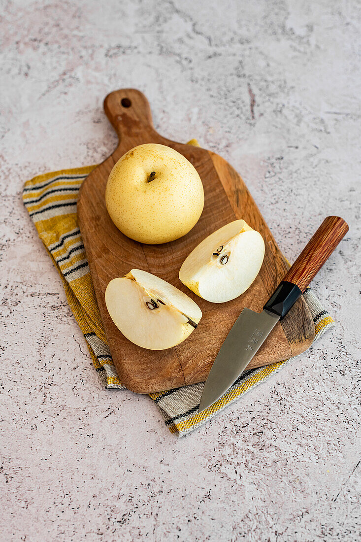Fresh Nashi pears (apple pears) on a wooden cutting board