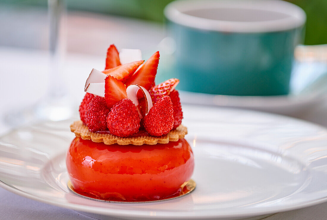 A mini mirror-glaze cake with raspberries and strawberries