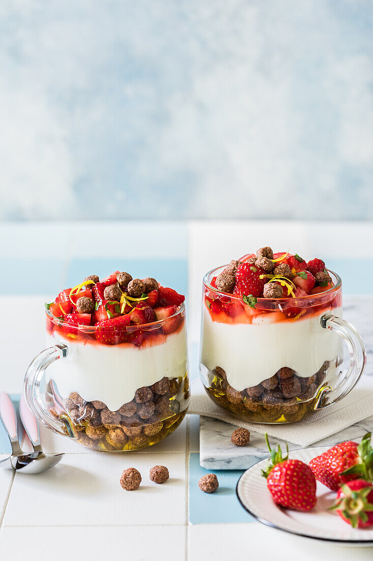 Breakfast yoghurt cups with honey, chocolate cereal balls, plain Greek yoghurt and stawberry tarragon salad