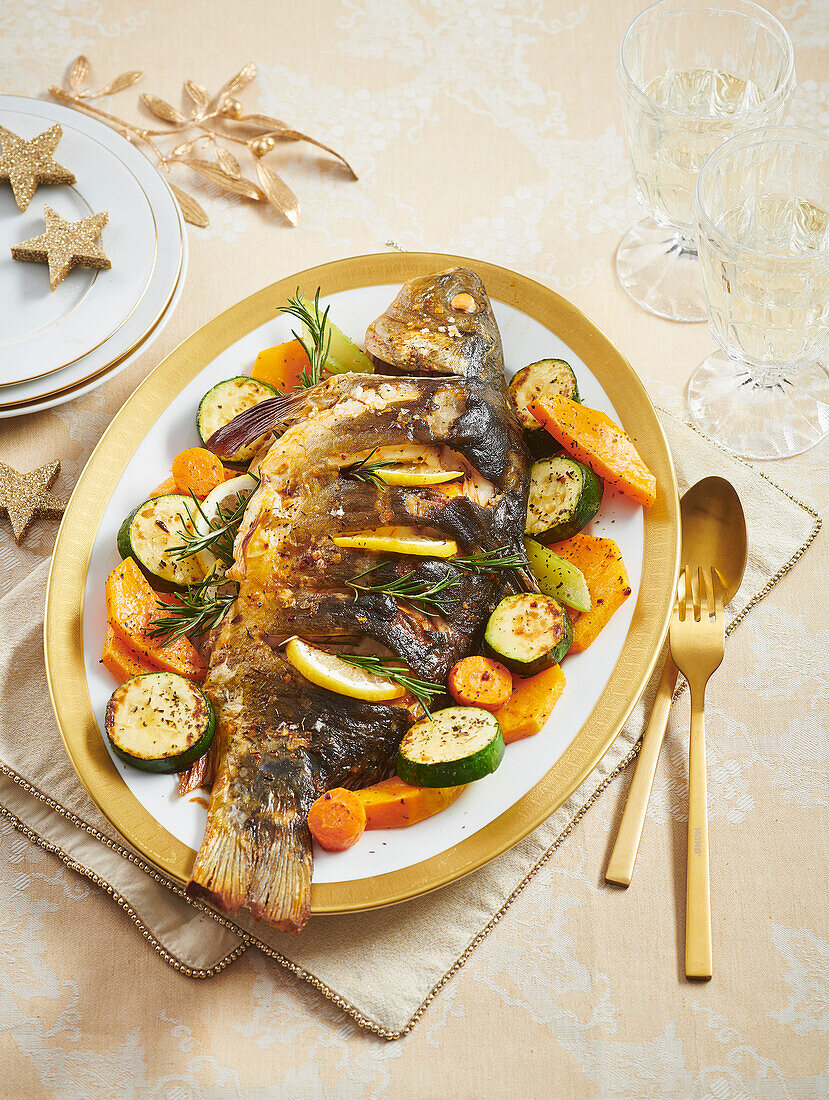 Oven-baked carp with lemon and vegetables for Christmas