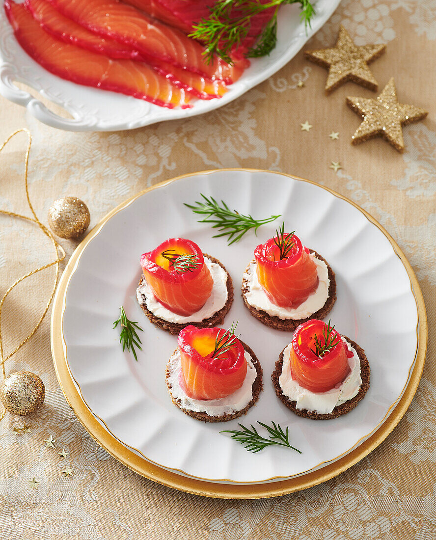 Pumpernickeltaler mit Frischkäse und in Rote-Bete-gebeiztem Lachs