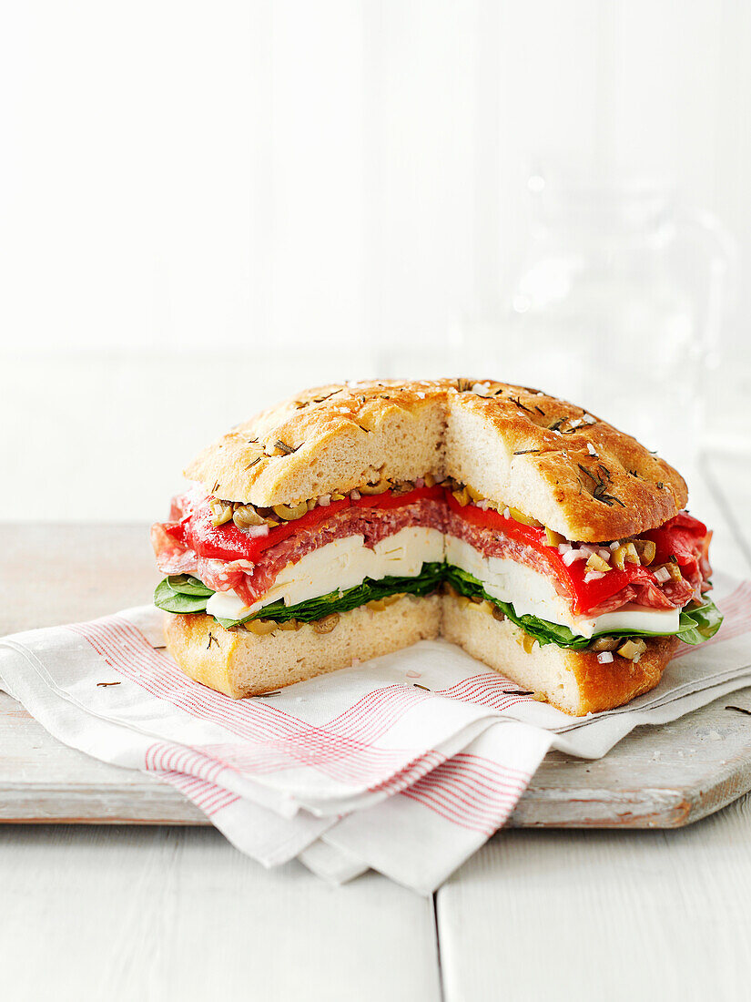 Italian picnic bread with mozzarella, salami, peppers, and olives